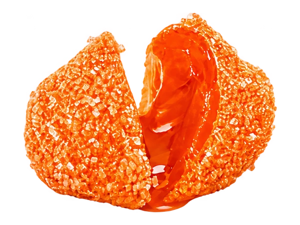 Tropical Mango candy split open to reveal its juicy center